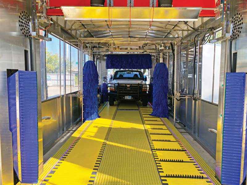 Truck entering car wash with dual belt conveyor