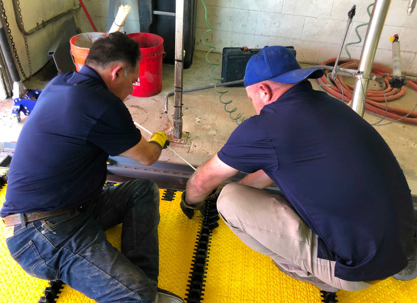 Two men working on a belt conveyor