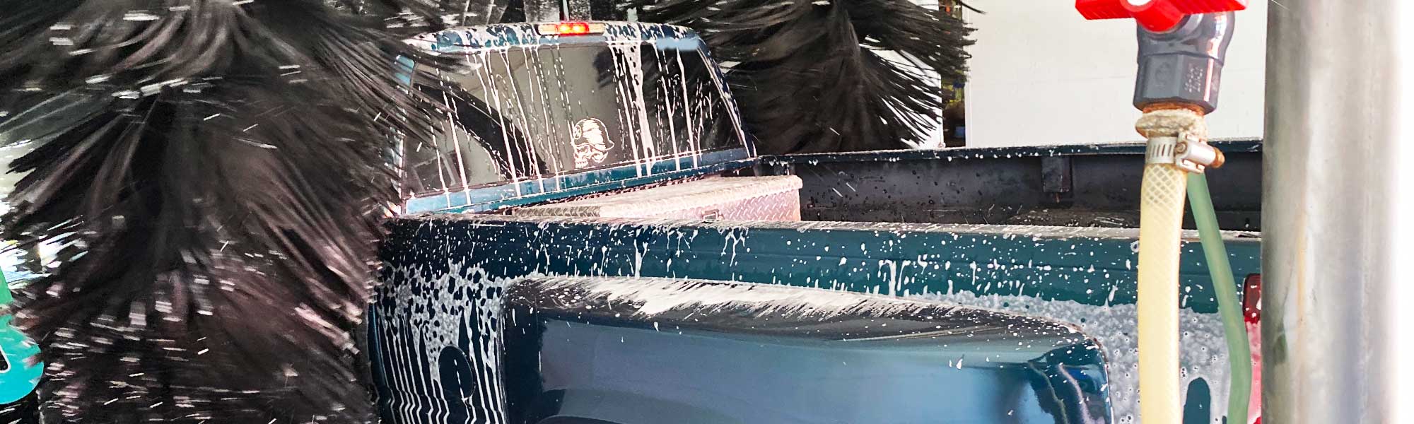 Green truck going through a ModBrite car wash