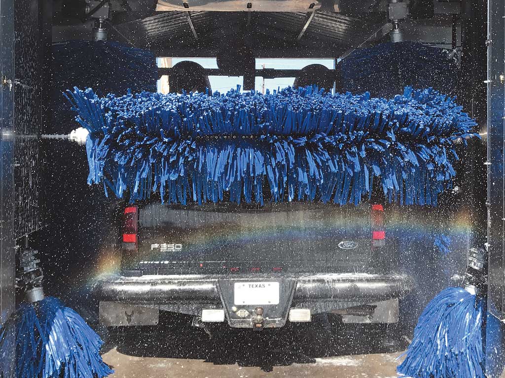 Dark truck going through the TriBrite car wash